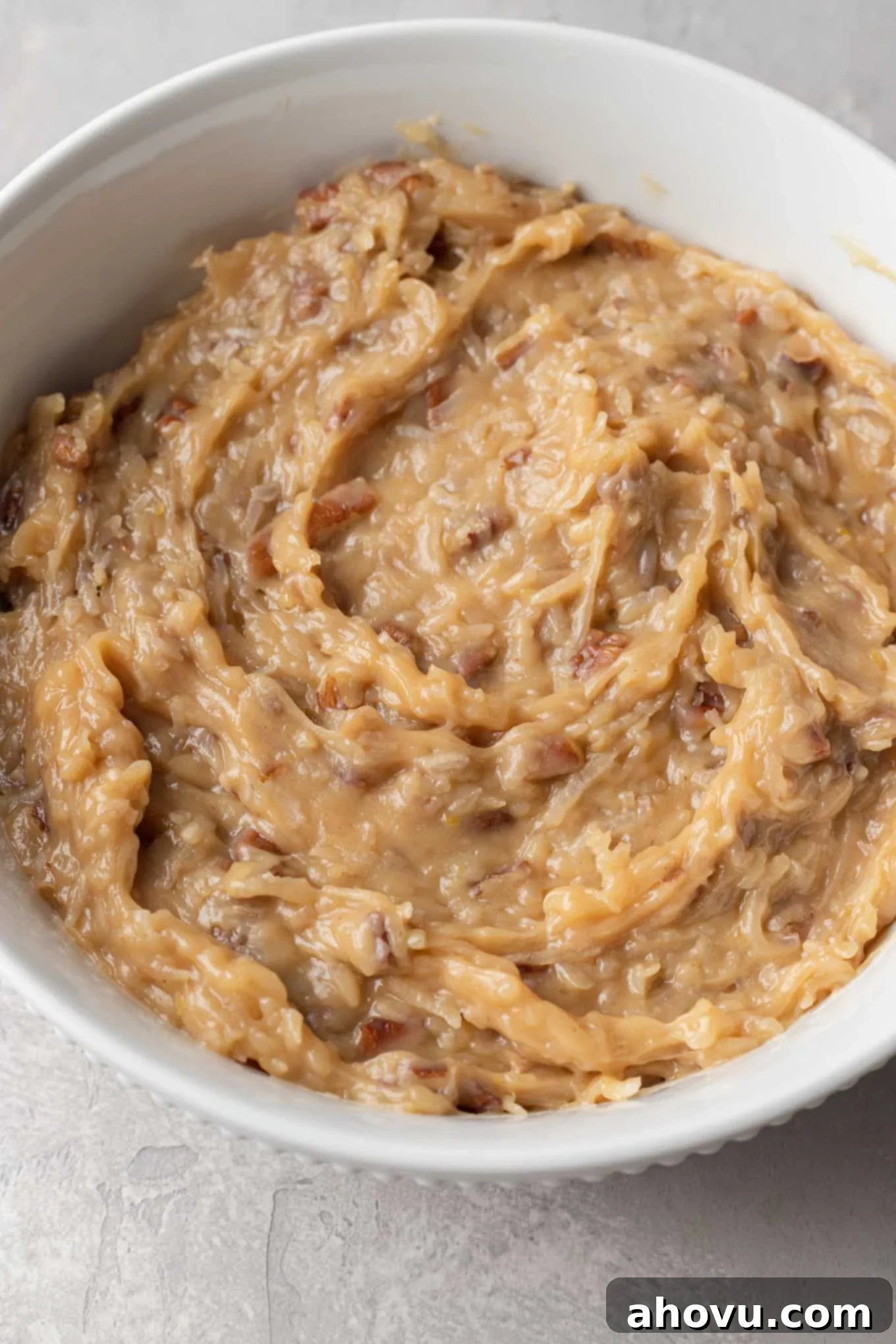 A large bowl of coconut pecan frosting for German chocolate cake, transferred to cool.