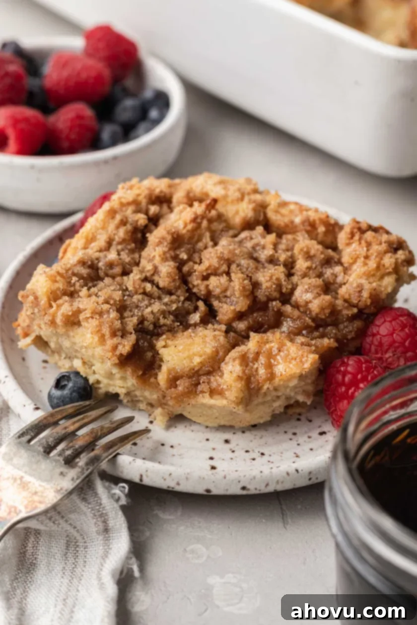 Sweet Morning French Toast Bake 2 A serving of challah french toast casserole on a small plate with fresh berries.