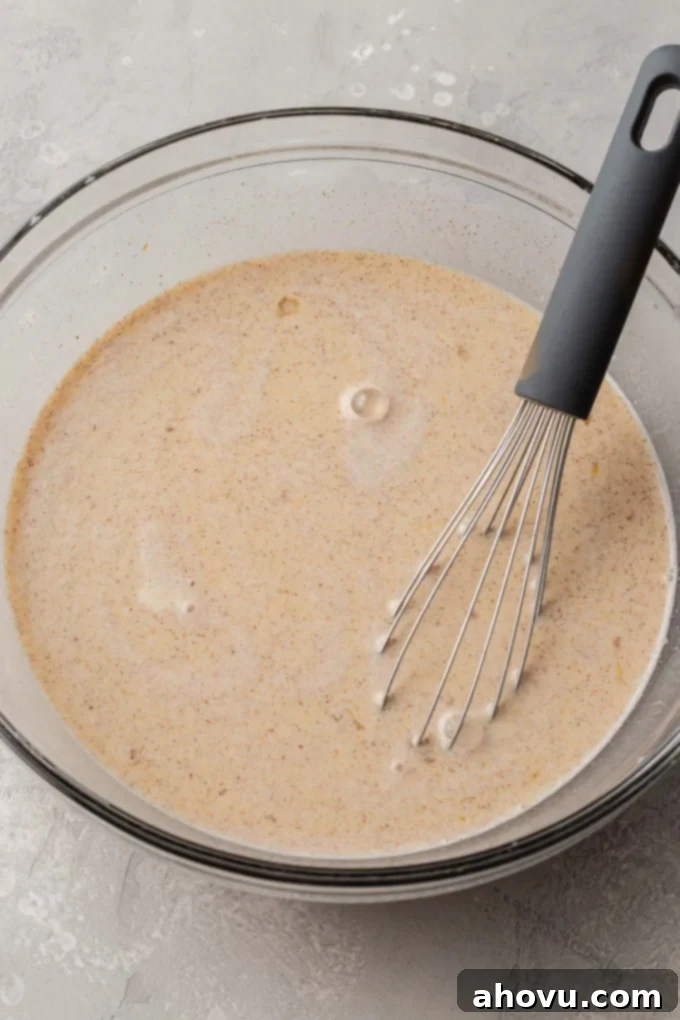 Sweet Morning French Toast Bake 5 A glass mixing bowl full of spiced custard.