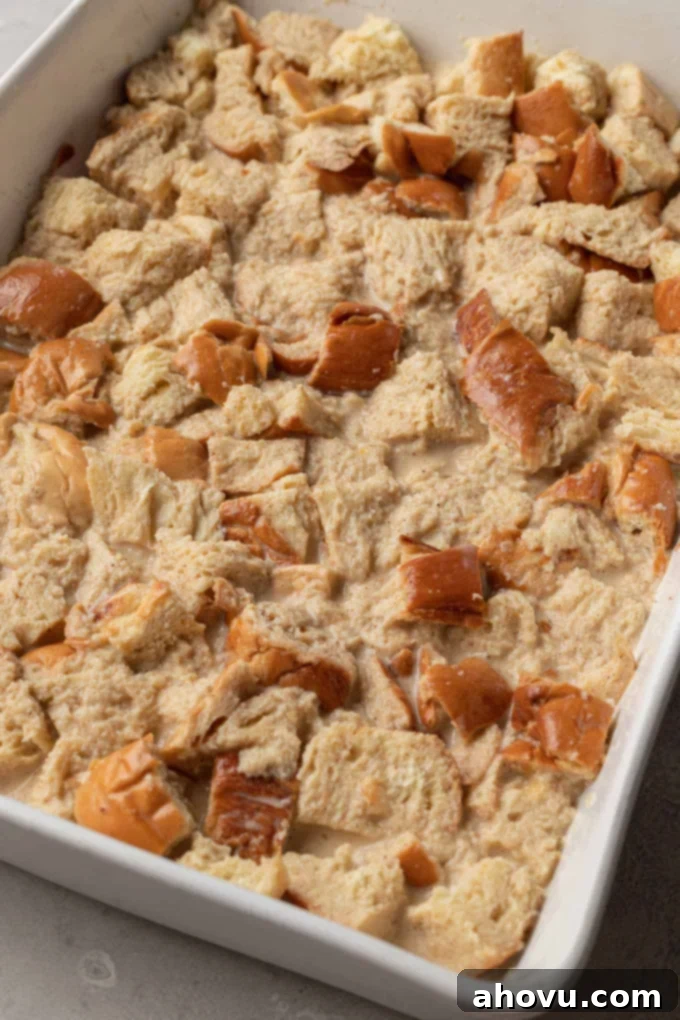 Sweet Morning French Toast Bake 6 Unbaked challah french toast casserole in a white baking dish.