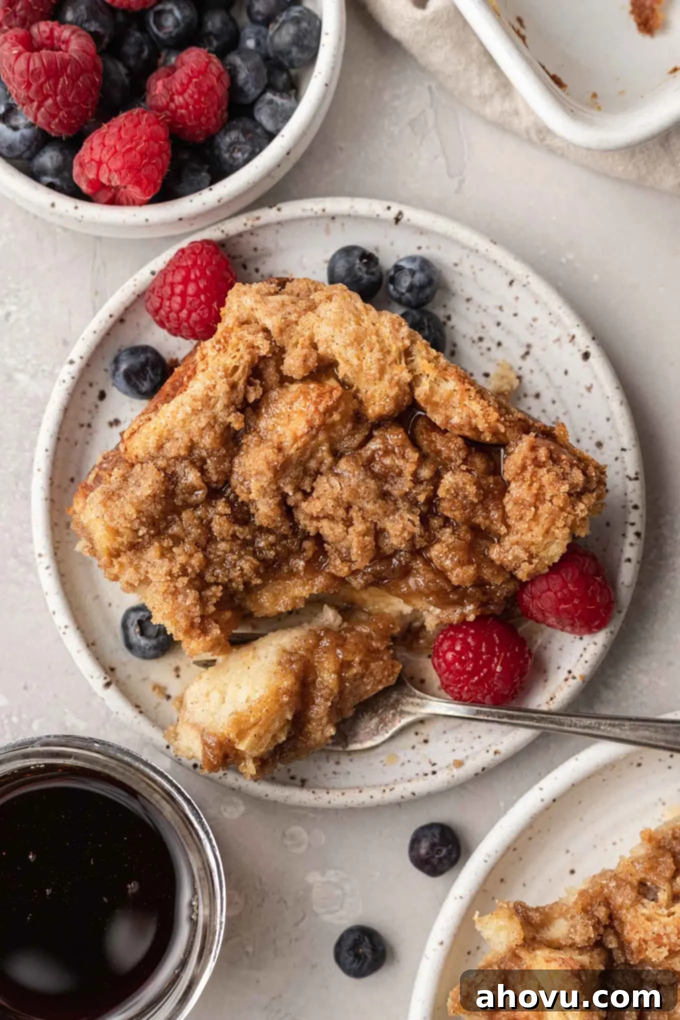Sweet Morning French Toast Bake 9 An overhead view of a serving of baked french toast casserole, with fresh berries on the side.