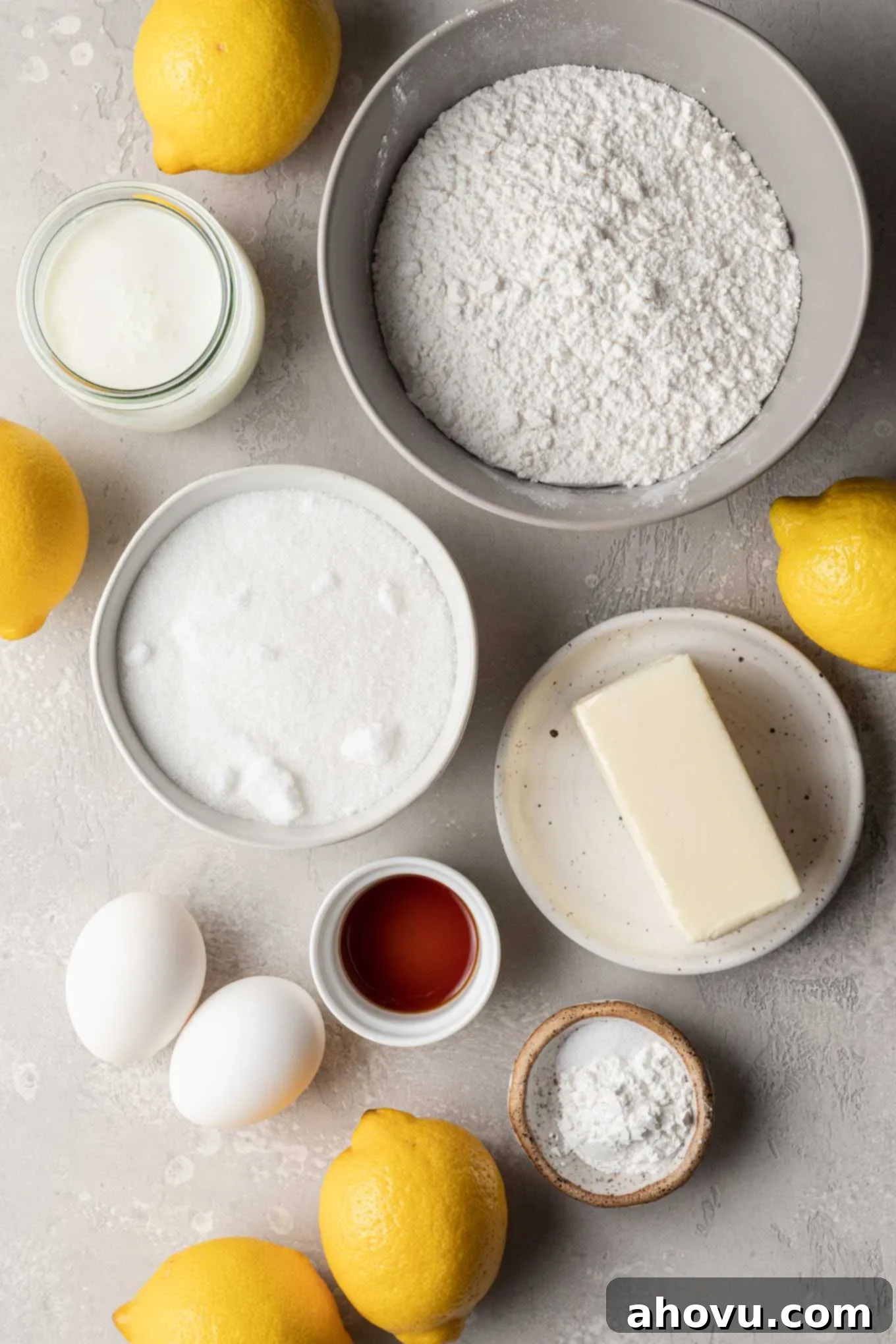 An overhead view showcasing all the carefully measured ingredients required to bake a batch of delicious, filled lemon cupcakes, neatly arranged on a kitchen counter.