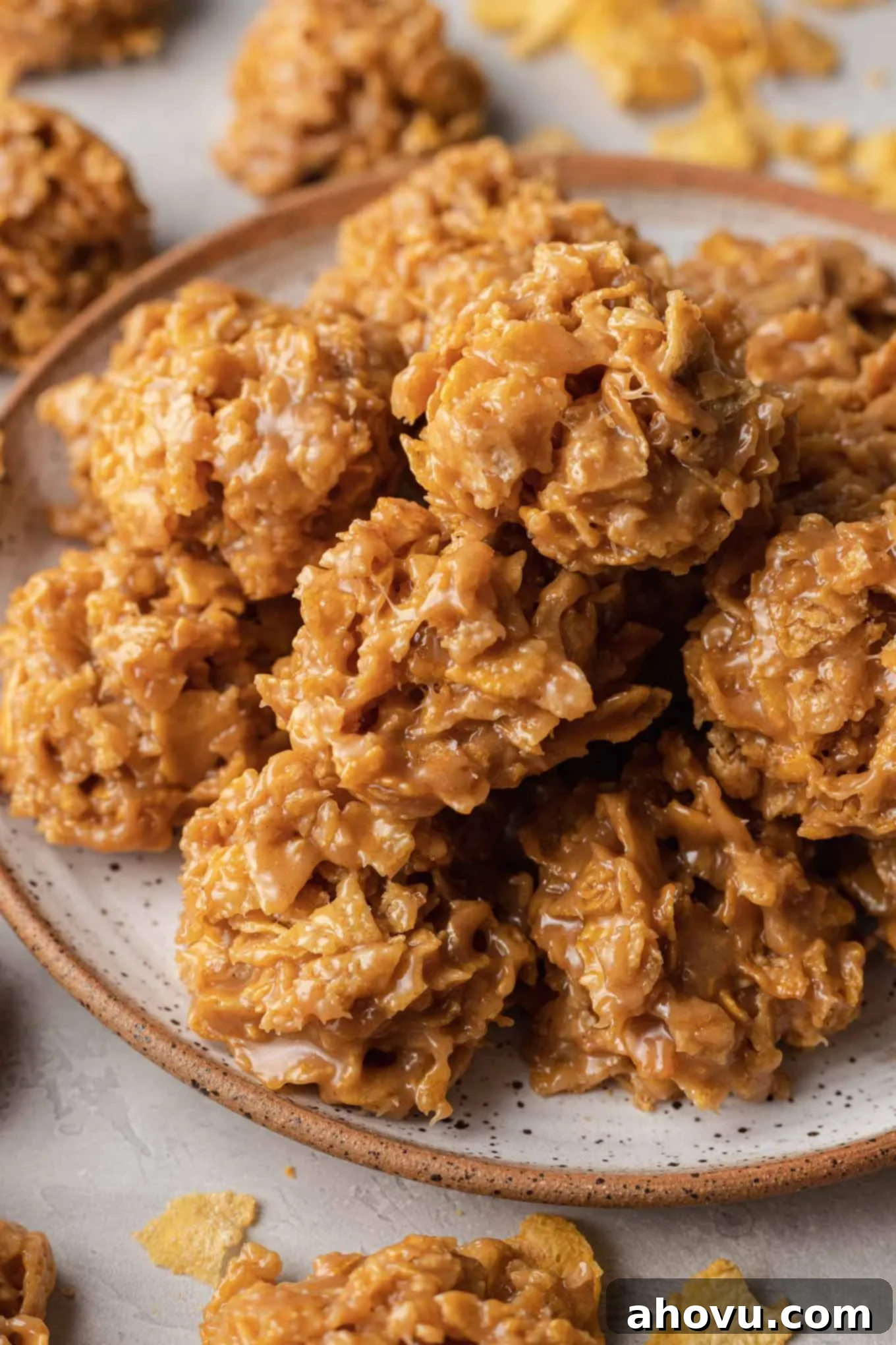 A plate piled high with crunchy and chewy no-bake peanut butter cornflake cookies, ready to be enjoyed.