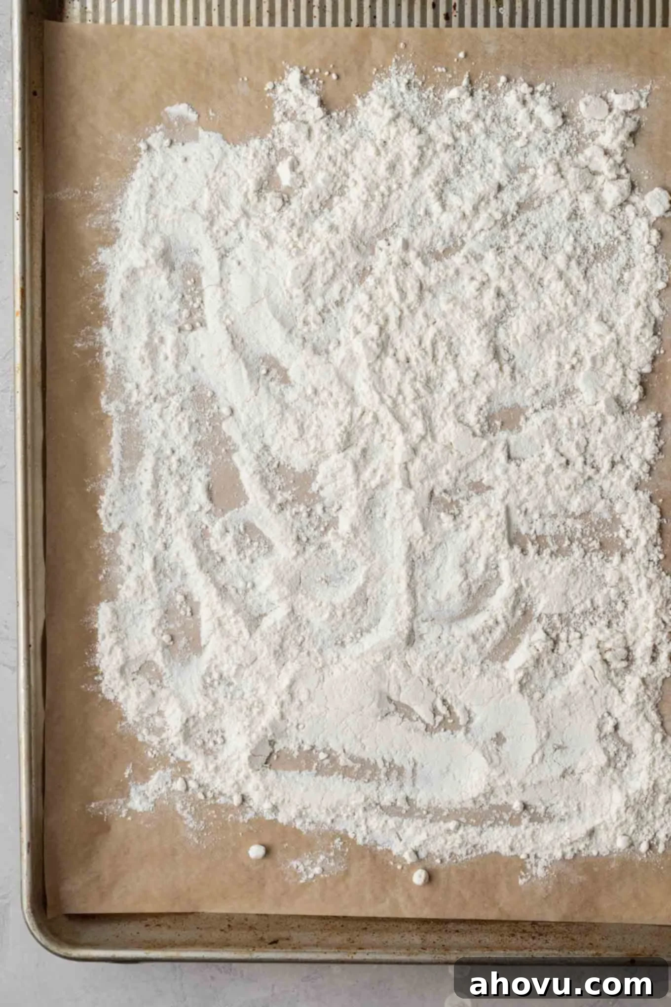 Dreamy Cookie Dough Dip 4 An overhead view of flour on a baking sheet.