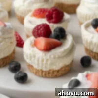 Several no-bake mini cheesecakes topped with fresh berries.