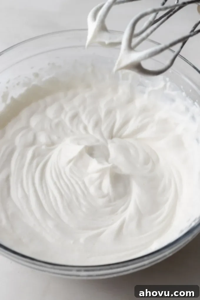 The Ultimate Homemade Ice Cream Cake 12 An overhead view of freshly whipped cream beaten to stiff peaks, perfect for frosting.