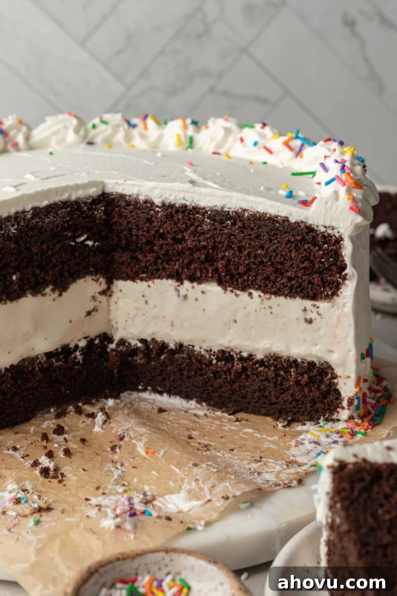 The Ultimate Homemade Ice Cream Cake 17 A beautifully sliced ice cream cake, showing its layered perfection, presented on an elegant cake stand.