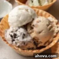 A scoopable portion of homemade no-churn ice cream served in a delightful waffle cone bowl, ready to be enjoyed.
