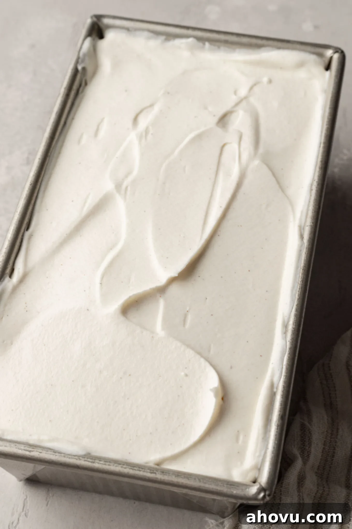 The smooth, creamy no-churn ice cream base evenly spread into a 9x5 inch loaf pan, ready for freezing.