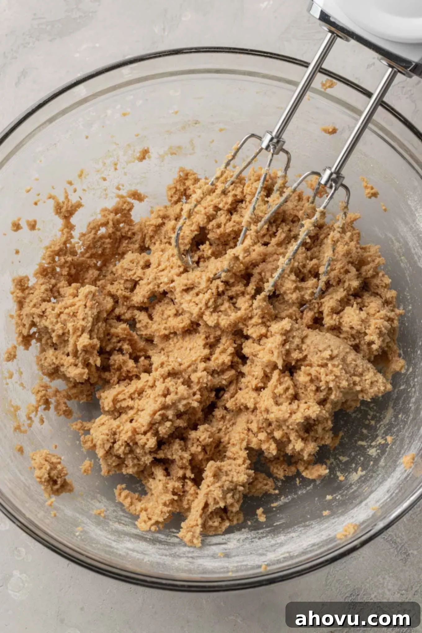 S'mores Bars 5 An overhead view of graham cracker cookie dough in a glass mixing bowl.