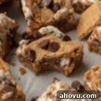 S'mores Bars 10 Several s'mores bars on a piece of white parchment paper.