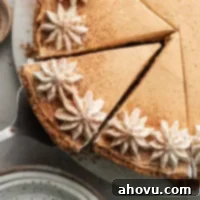 A close-up overhead view of a no-bake pumpkin cheesecake that's been sliced, revealing its creamy layers and spiced crust.
