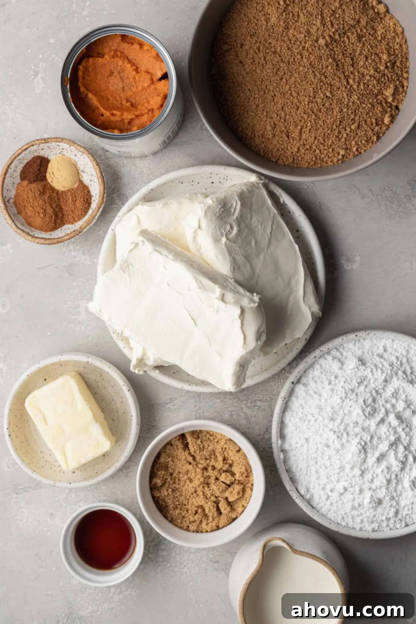 An overhead view of the fresh and pantry ingredients laid out for making a pumpkin no-bake cheesecake.