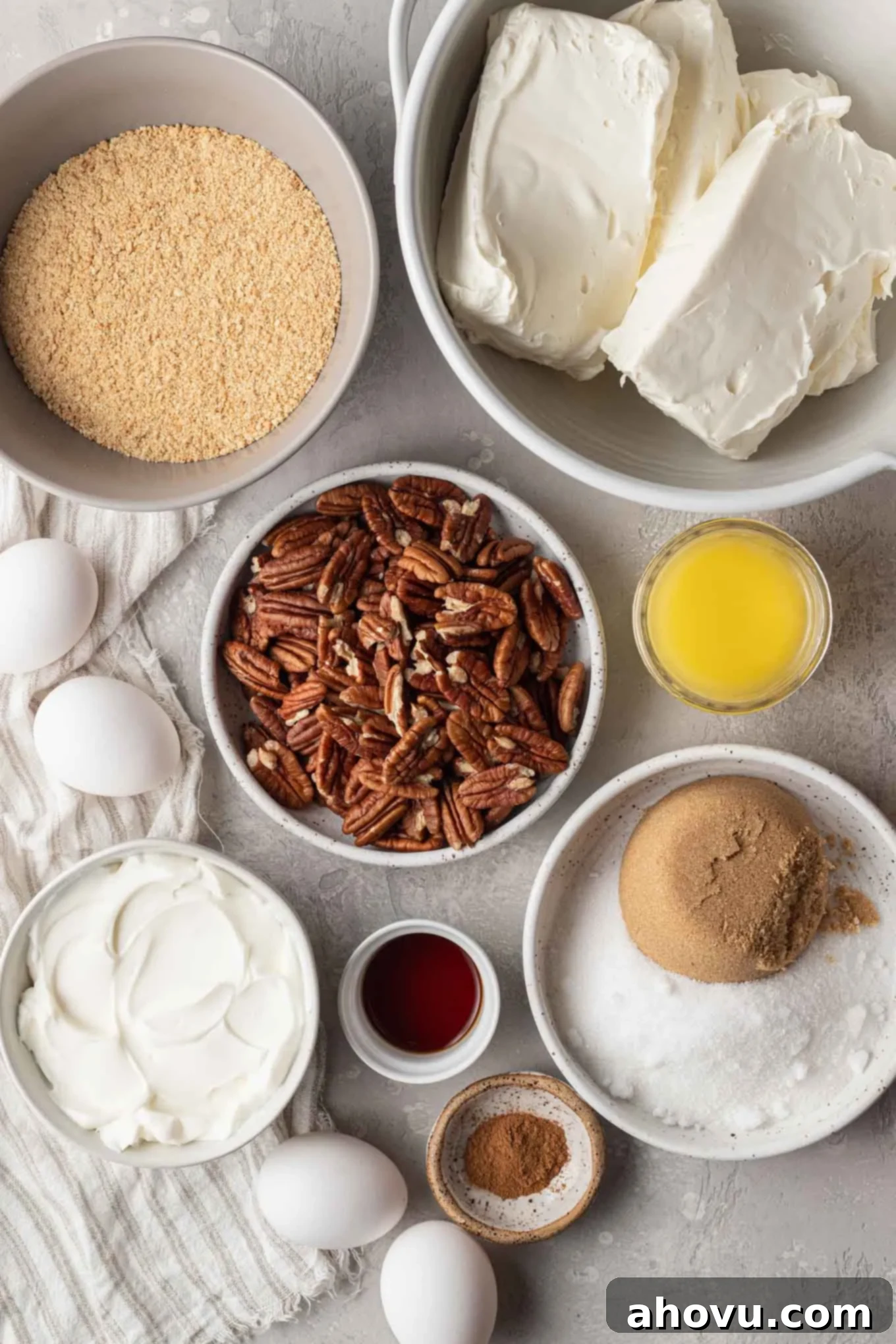 An overhead view of the ingredients needed to make a pecan cheesecake. 
