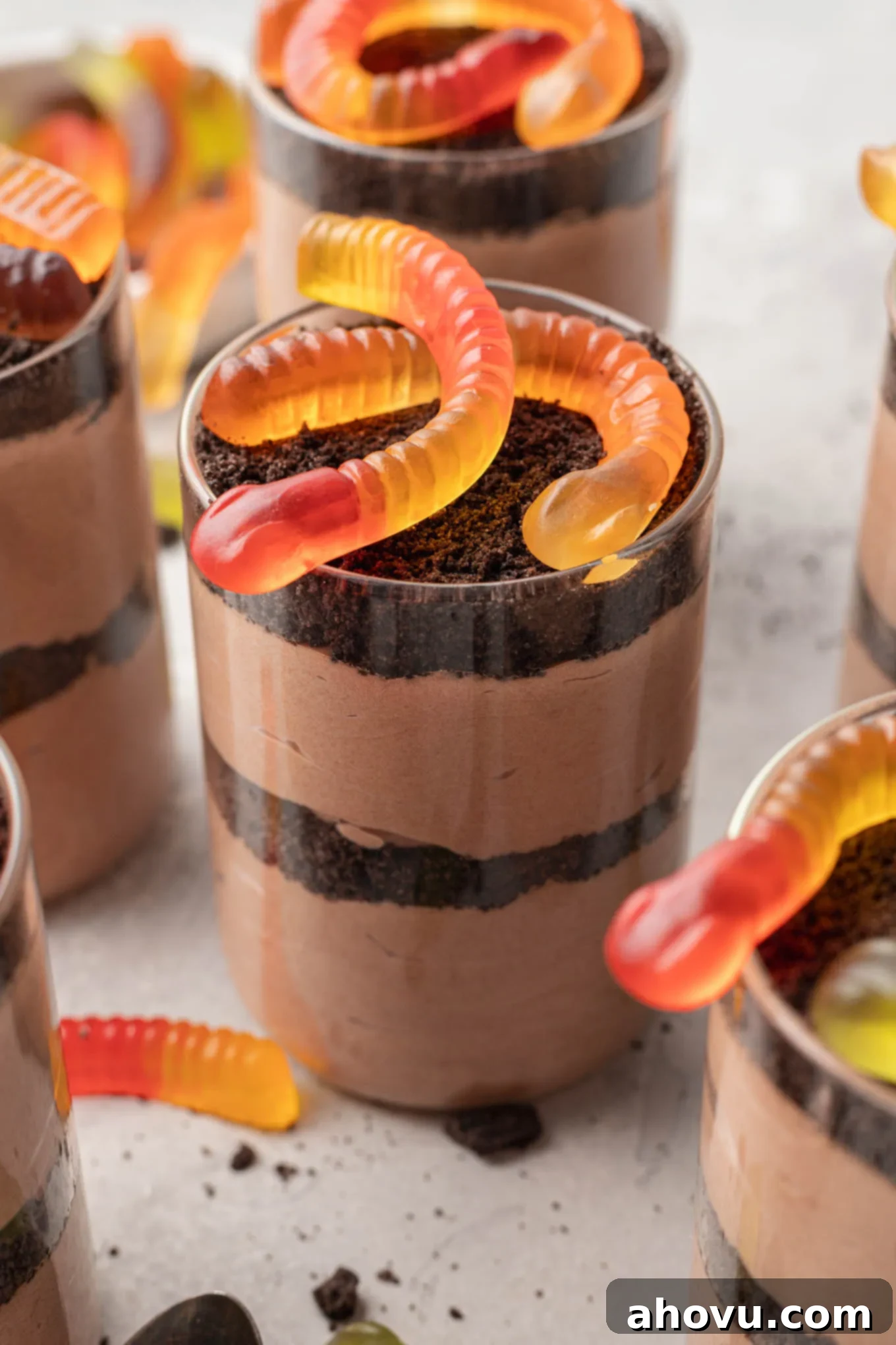 Delightful dirt cups beautifully topped with classic gummy worms, ready for serving.