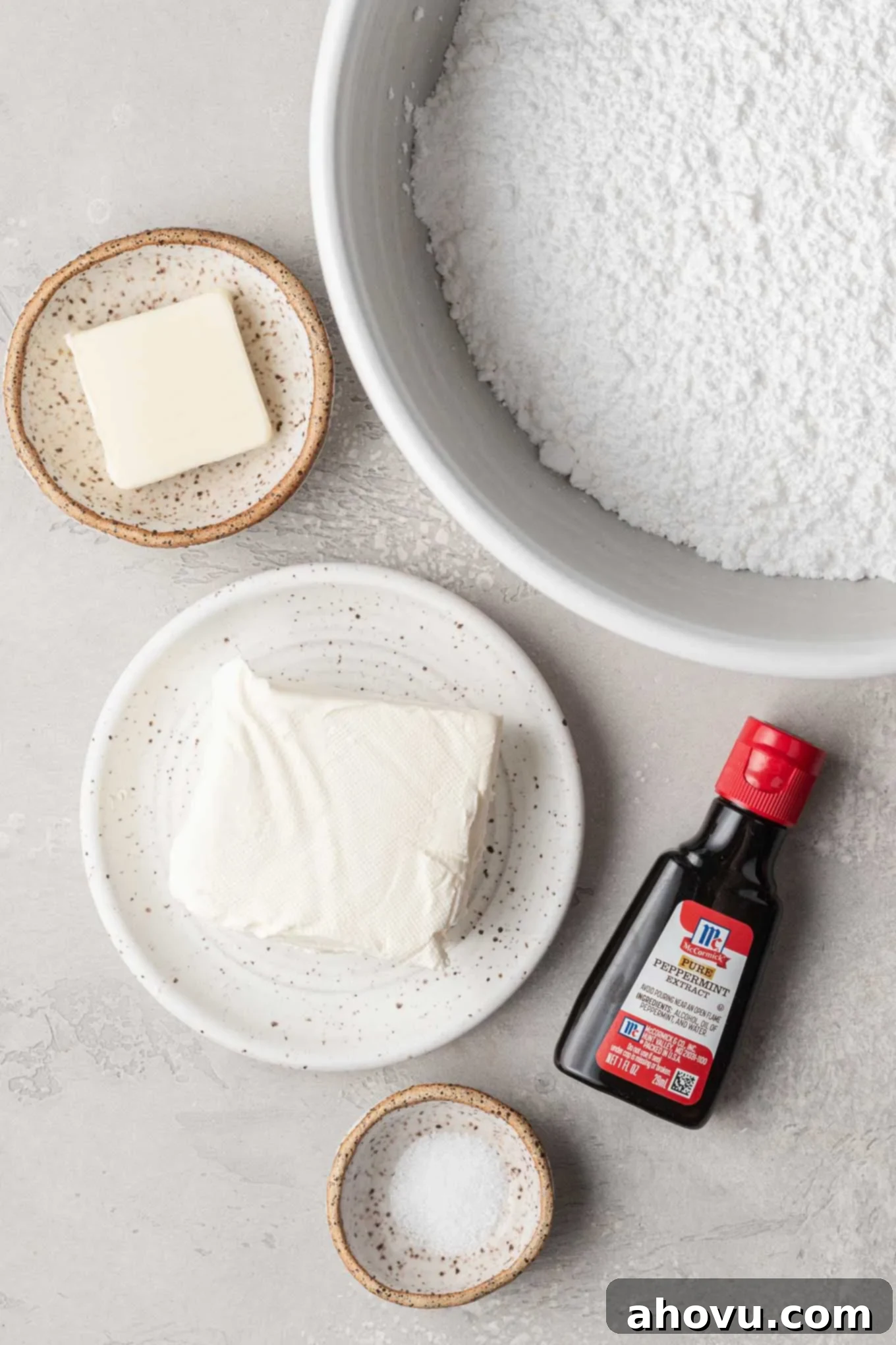 Creamy Dream Mints 3 An overhead view of the simple ingredients arranged for making cream cheese wedding mints: cream cheese, butter, powdered sugar, peppermint extract, and salt.