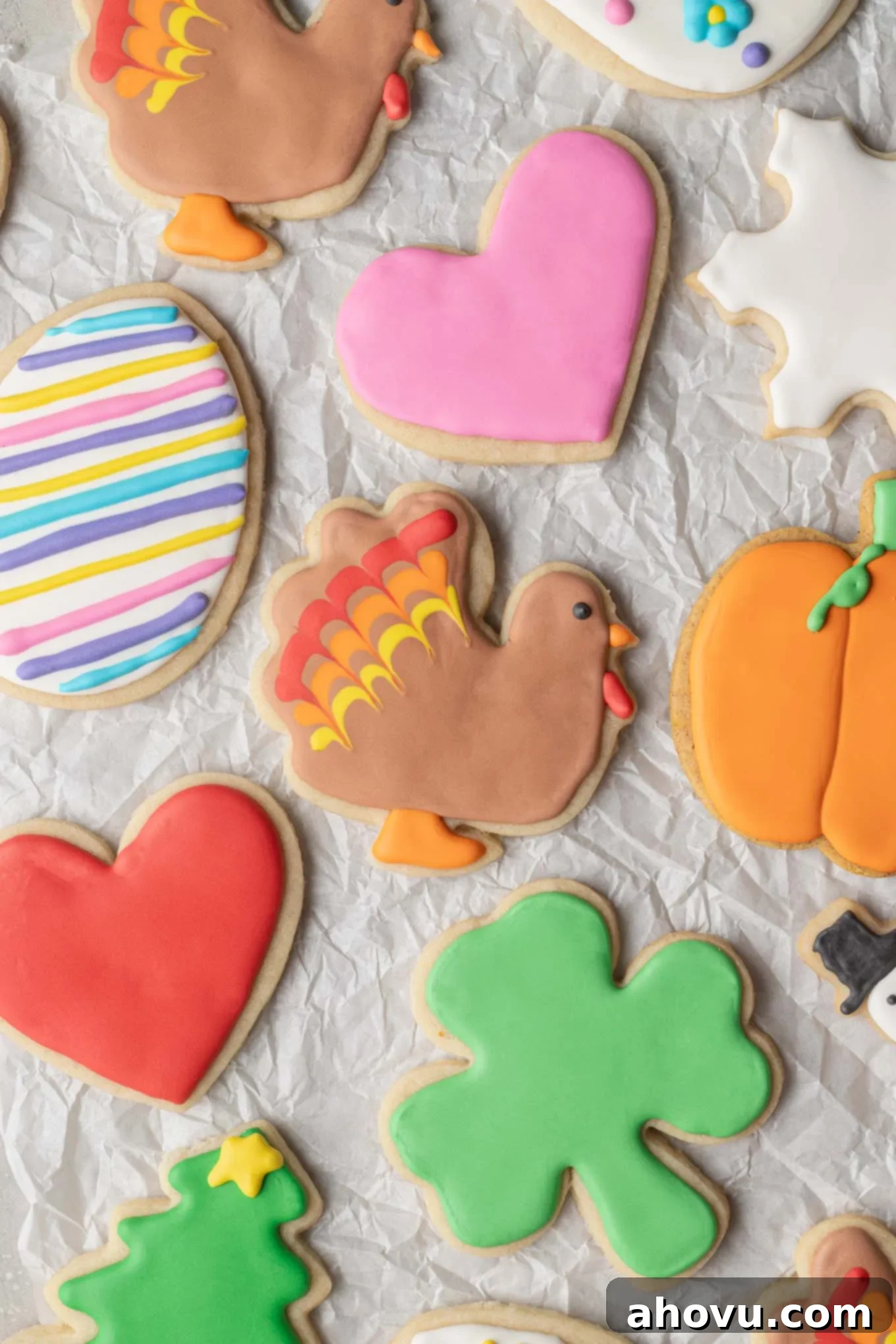An inviting overhead view of various delightful sugar cookies, each expertly decorated with smooth, colorful royal icing, arranged artfully.