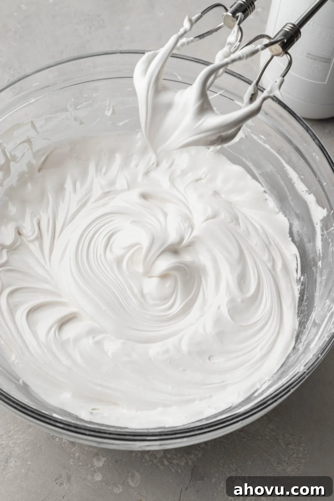 A bowl of royal icing with a slightly softer texture, showing gentle soft peaks ideal for outlining.