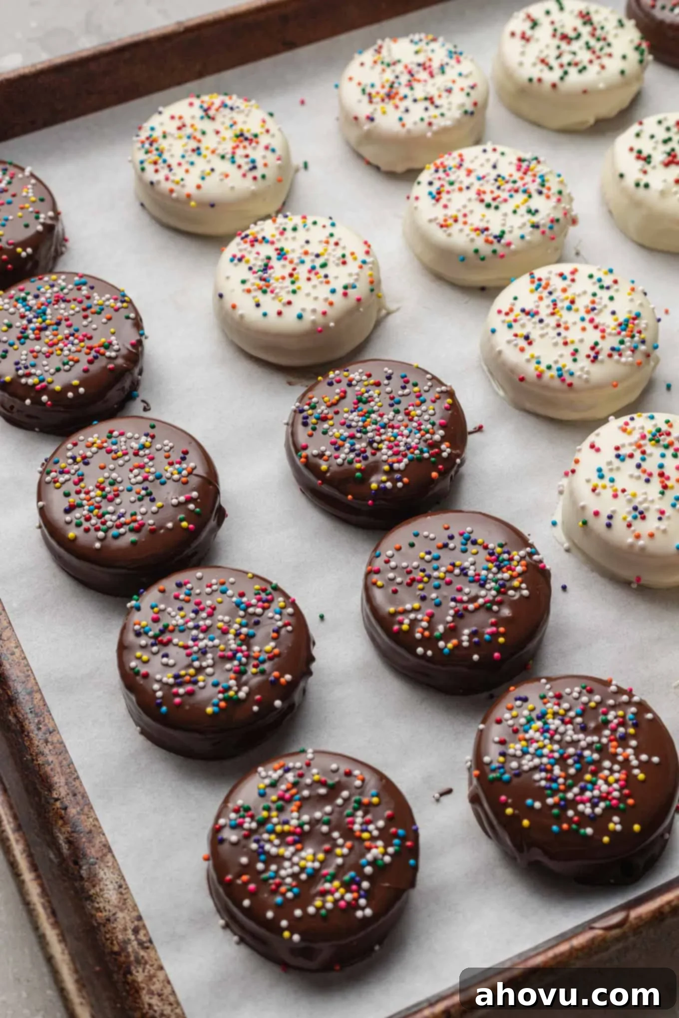 A process short showing rows of chocolate-dipped Ritz cracker cookies on a baking sheet. 
