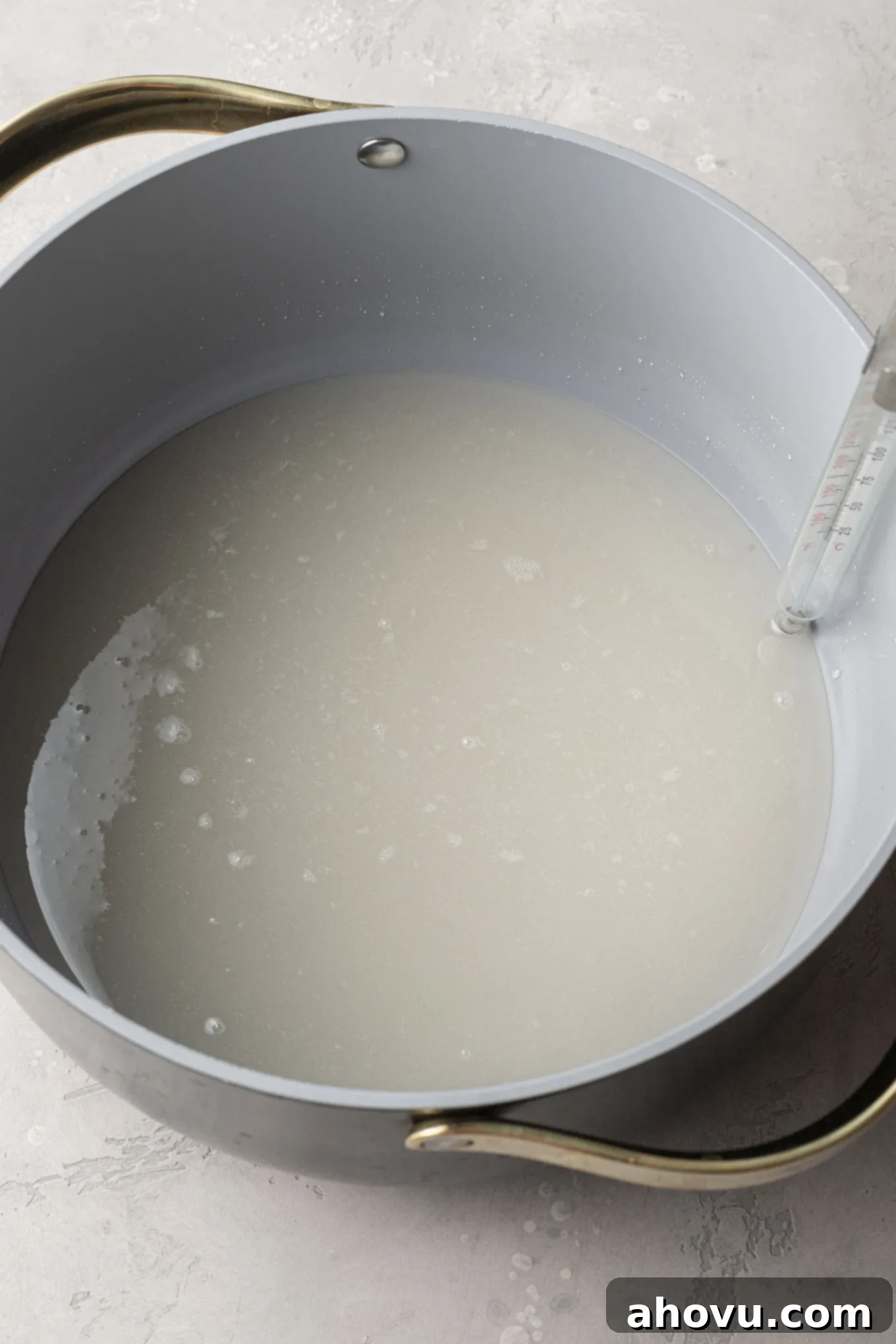 Golden Peanut Brittle 4 An overhead view of corn syrup and sugar in a saucepan, beginning to heat.