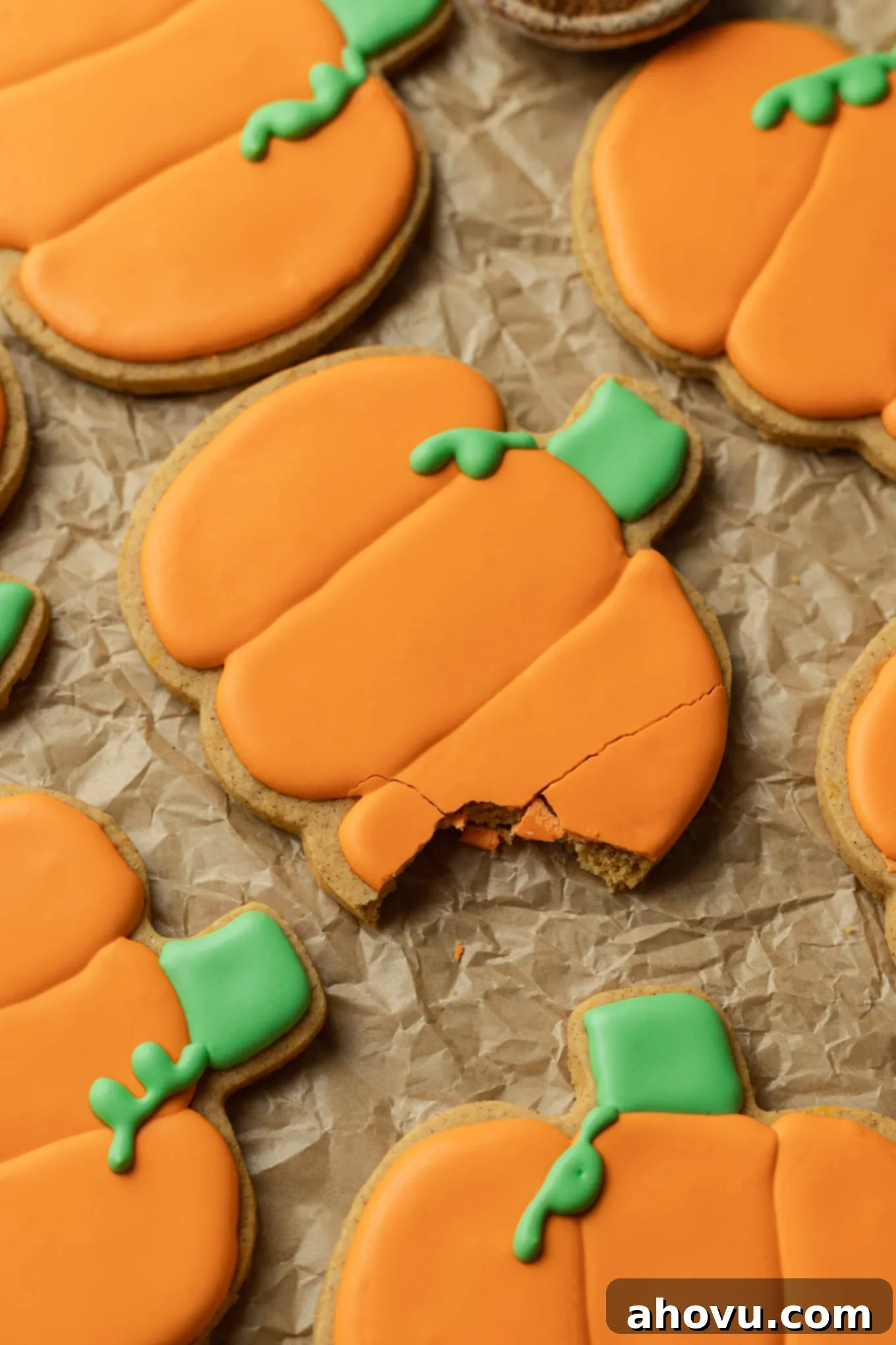 Autumn Pumpkin Sugar Cookies 11 A close-up look at a pumpkin shaped sugar cookie with a bite missing.