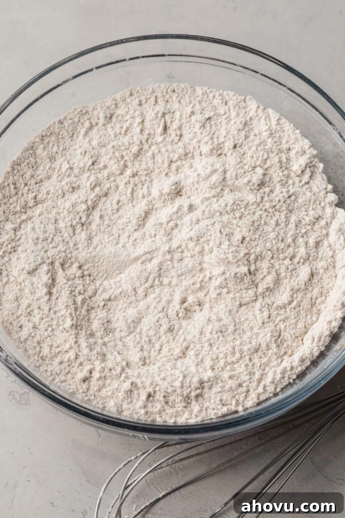 Autumn Pumpkin Sugar Cookies 4 An overhead view of dry cookie ingredients in a glass mixing bowl.