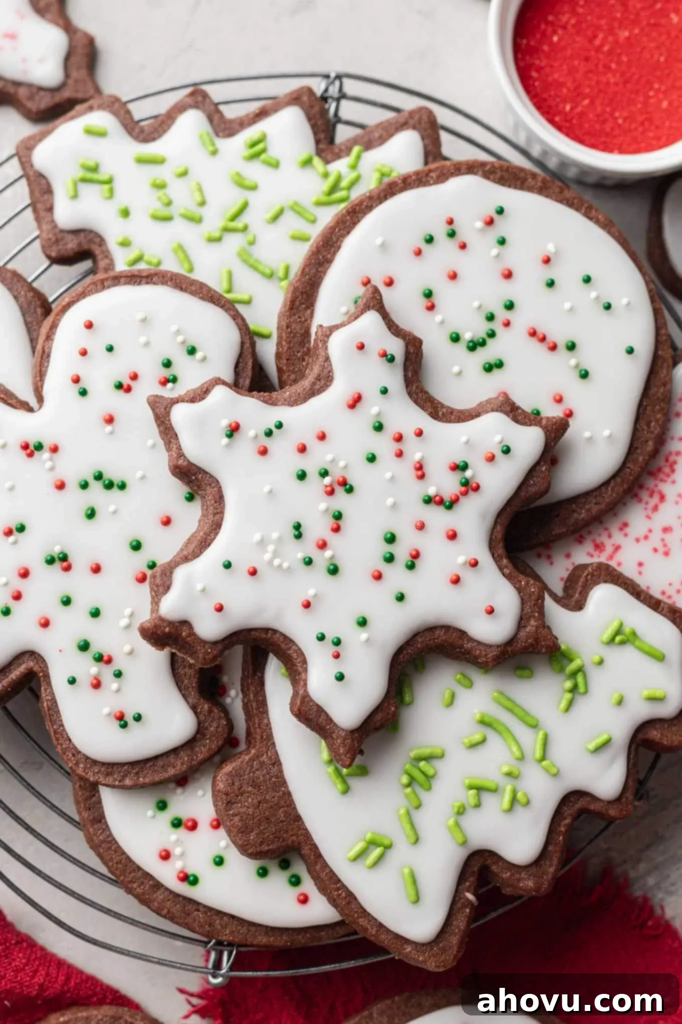 An overhead view of fresh chocolate sugar cookies stacked neatly on a wire cooling rack, just out of the oven.