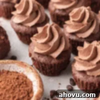 Several brownie bites topped with chocolate whipped cream.
