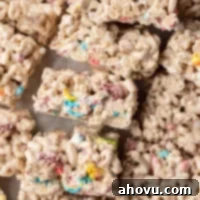 Lucky Charms Treats 10 An overhead view of several colorful Lucky Charms treats laying on their side, showing their delightful layers.