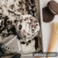 Midnight Cookie Dream 10 An overhead view of Oreo ice cream in a loaf pan. An ice cream scoop with a scoop of ice cream sits on top of the loaf pan.