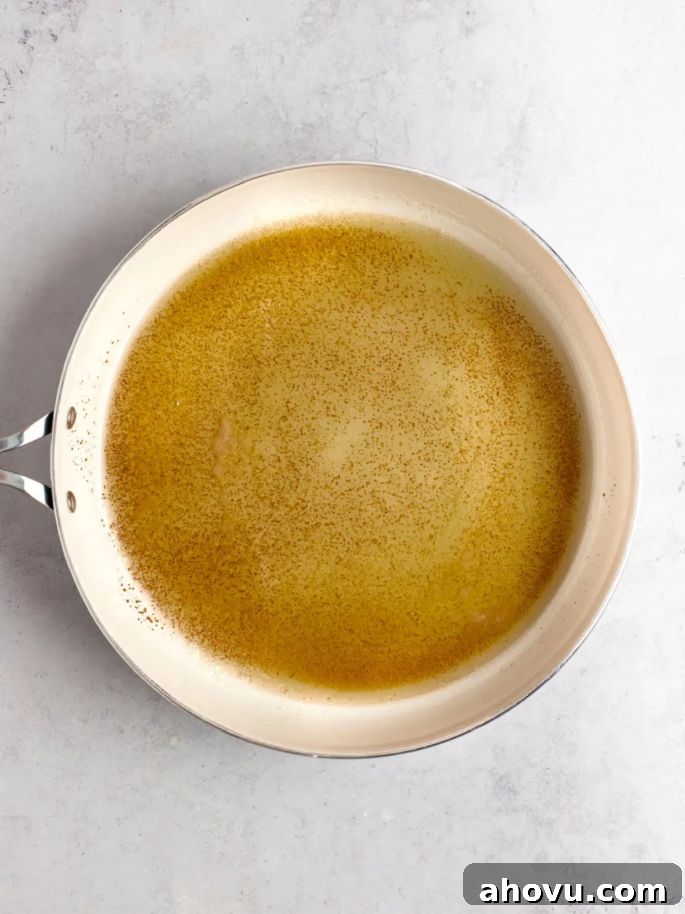 The Art of Brown Butter 7 Richly browned butter with visibly toasted milk solids gathered at the bottom of a white skillet.