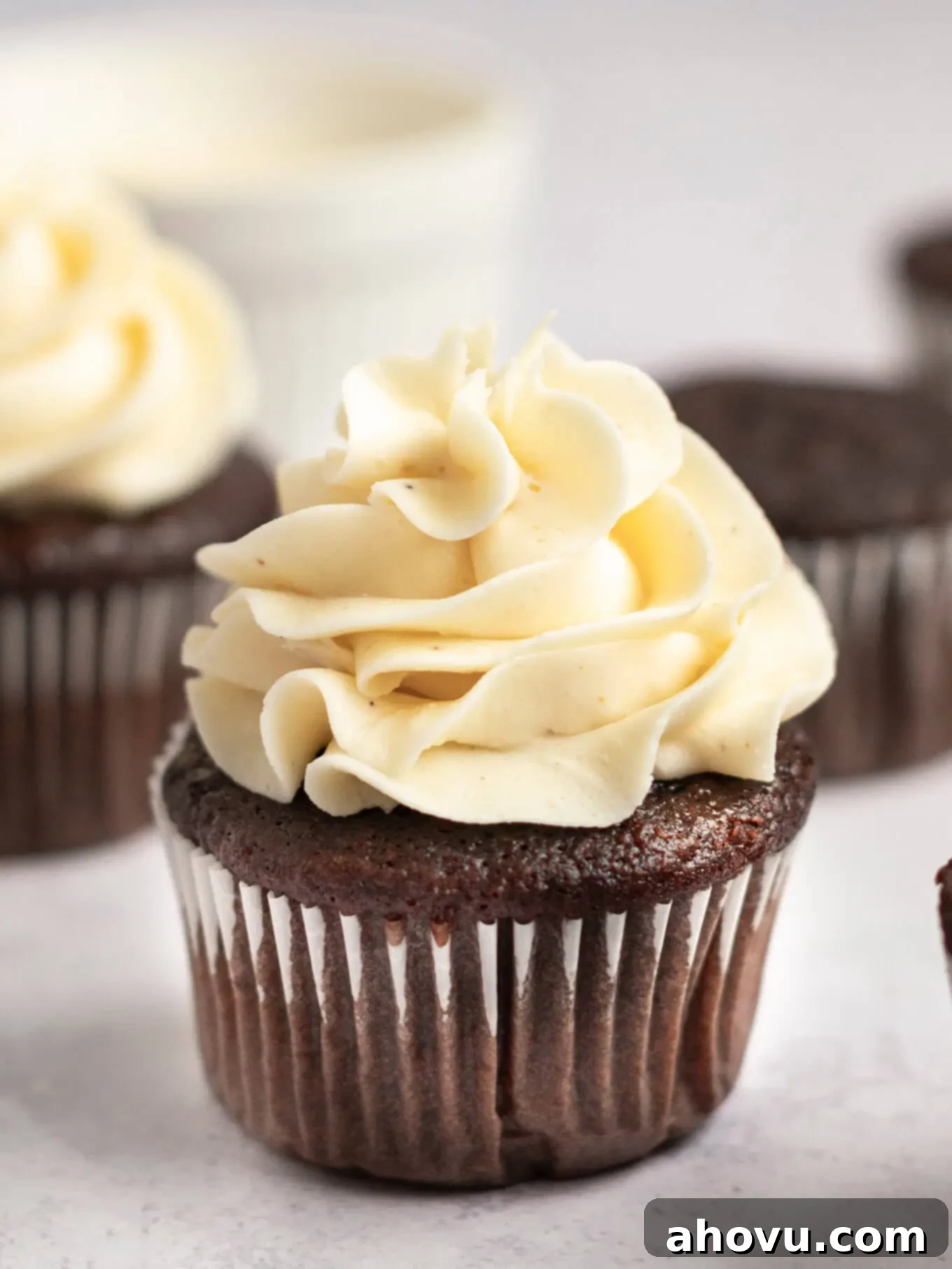 A chocolate cupcake topped with rich, creamy brown butter frosting, garnished with a sprinkle of sea salt.