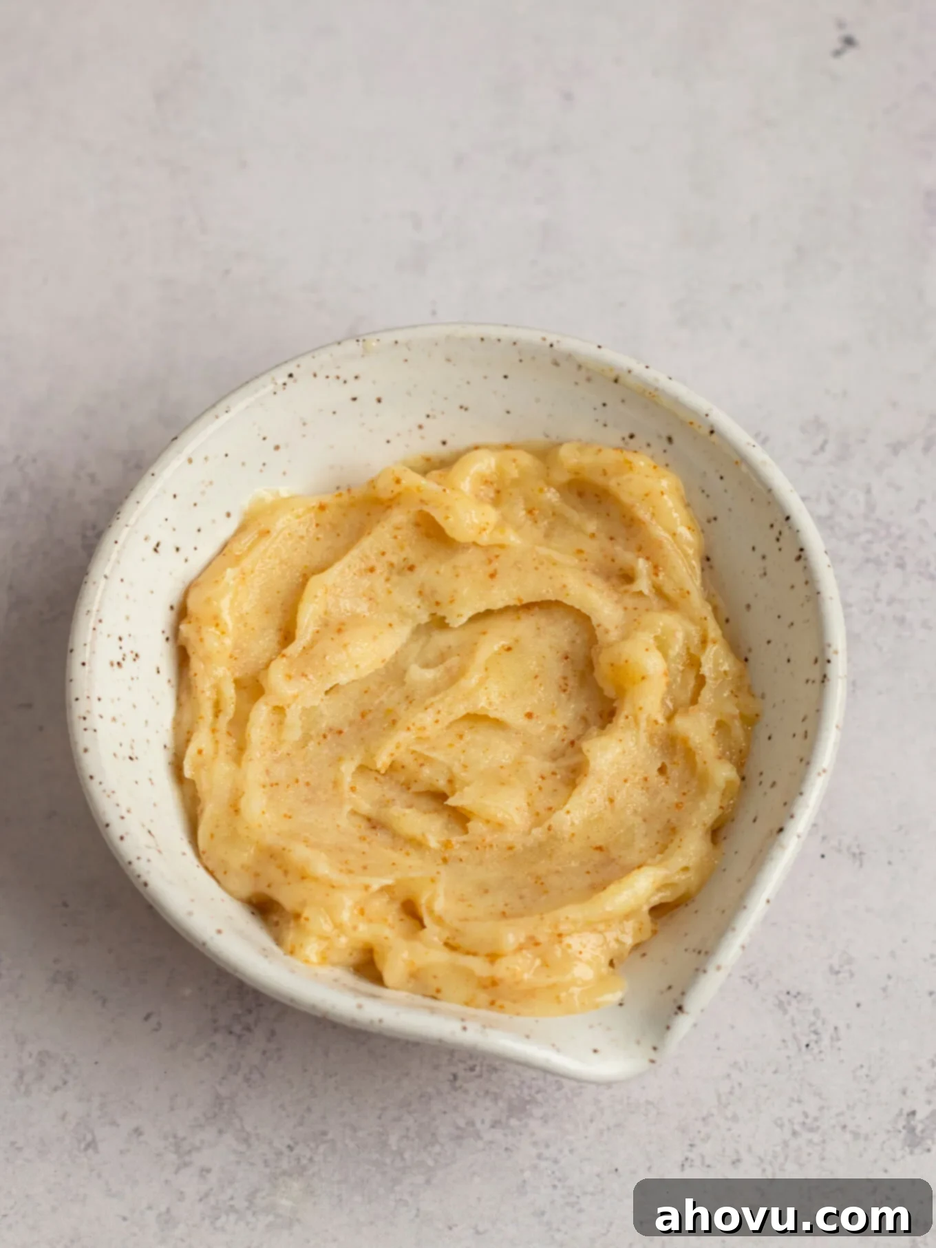 A bowl filled with solidified browned butter, ready to be incorporated into the frosting.