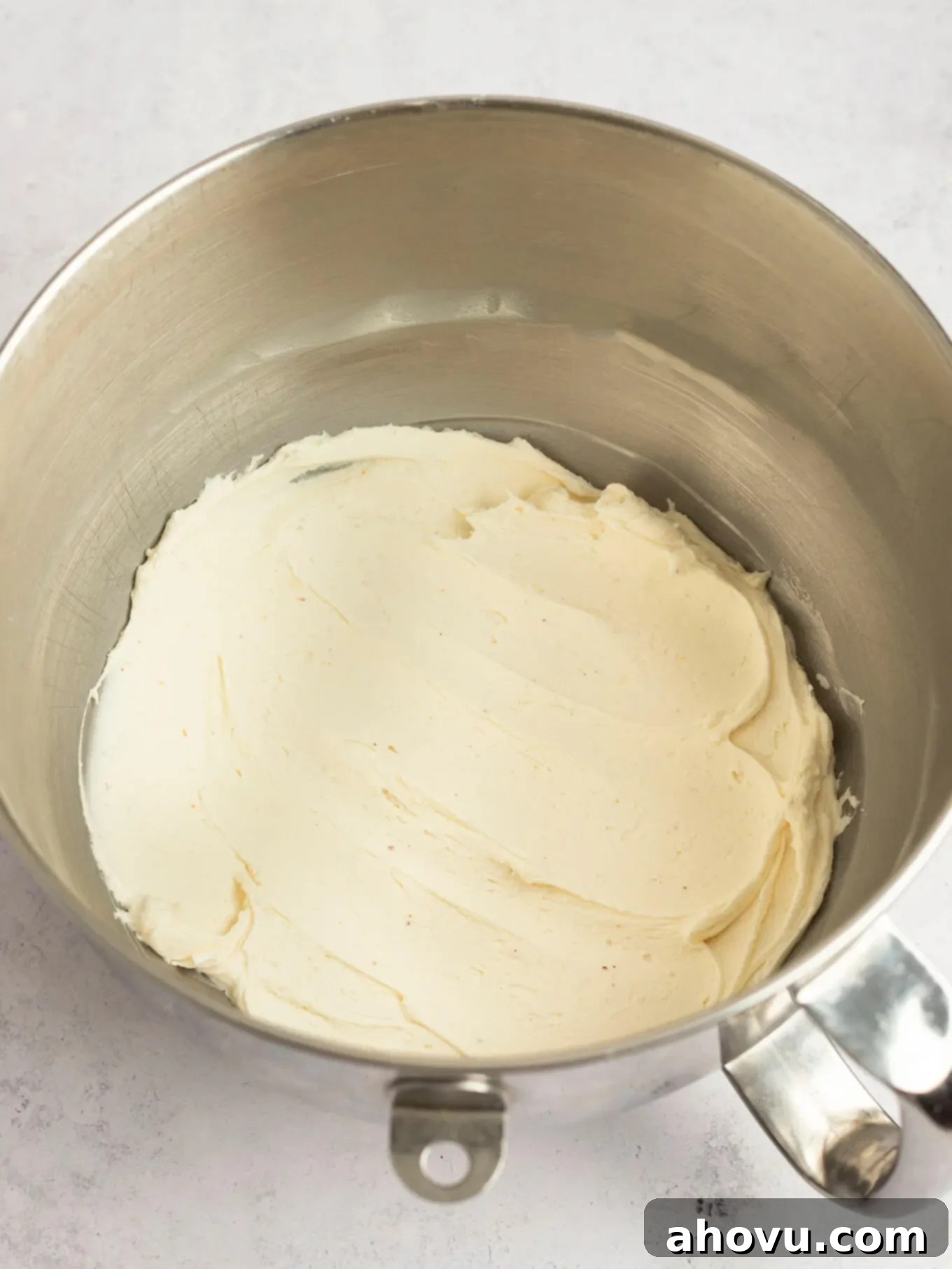 Beautifully mixed brown butter frosting swirled in the bowl of a stand mixer, showcasing its creamy texture.