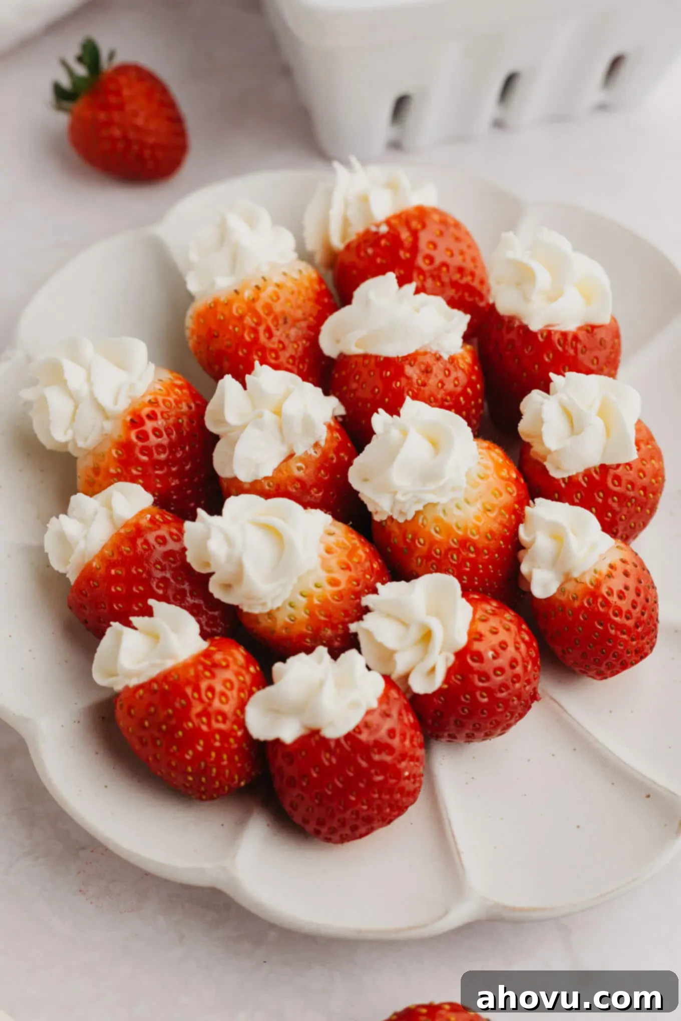 Strawberry Cheesecake Poppers 2 A plate of vibrant cheesecake stuffed strawberries, ready to be enjoyed.
