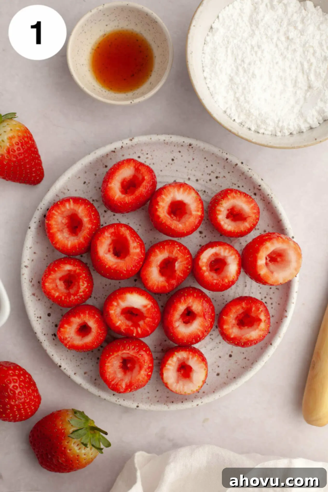 Strawberry Cheesecake Poppers 4 A process shot showing several strawberries that have been precisely hollowed out, ready for filling.
