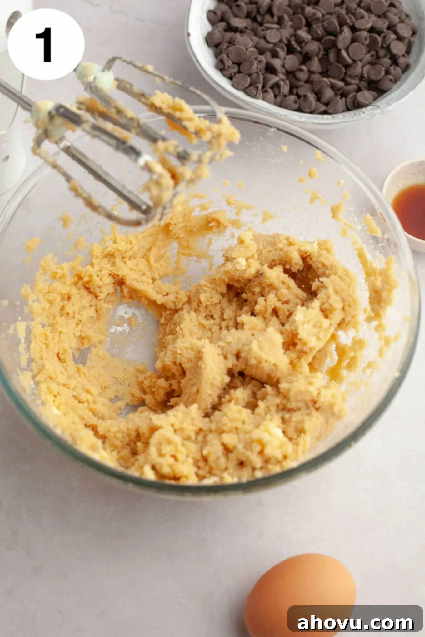 A glass mixing bowl with softened butter, cream cheese, brown sugar, and granulated sugar perfectly creamed together.