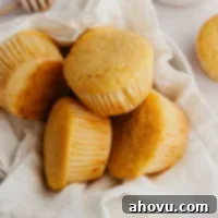 A bowl filled with several cornbread muffins.