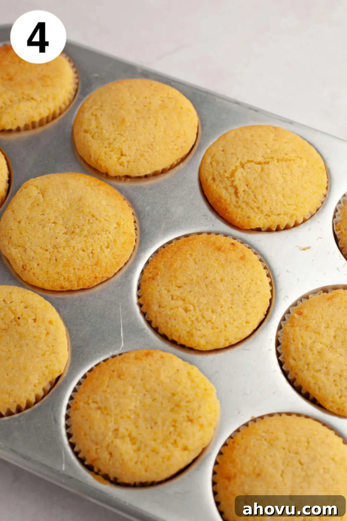 Baked cornbread muffins in a muffin pan. 