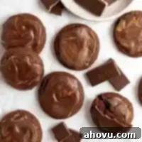 An overhead view of several Andes mint cookies spread out on a piece of parchment paper.