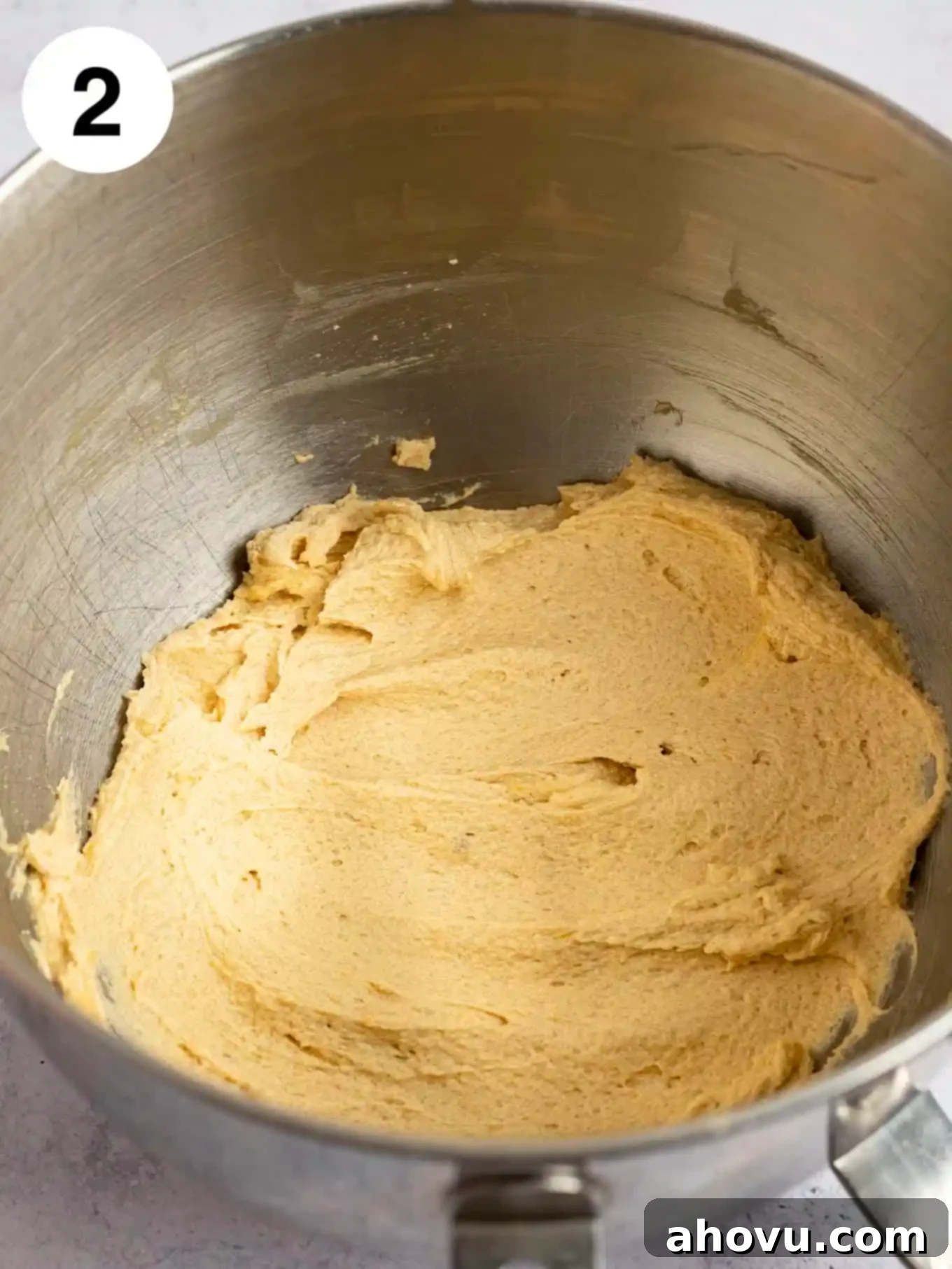 The wet ingredients, including softened butter, brown sugar, and granulated sugar, creamed together in the bowl of a stand mixer, forming a light and fluffy mixture.