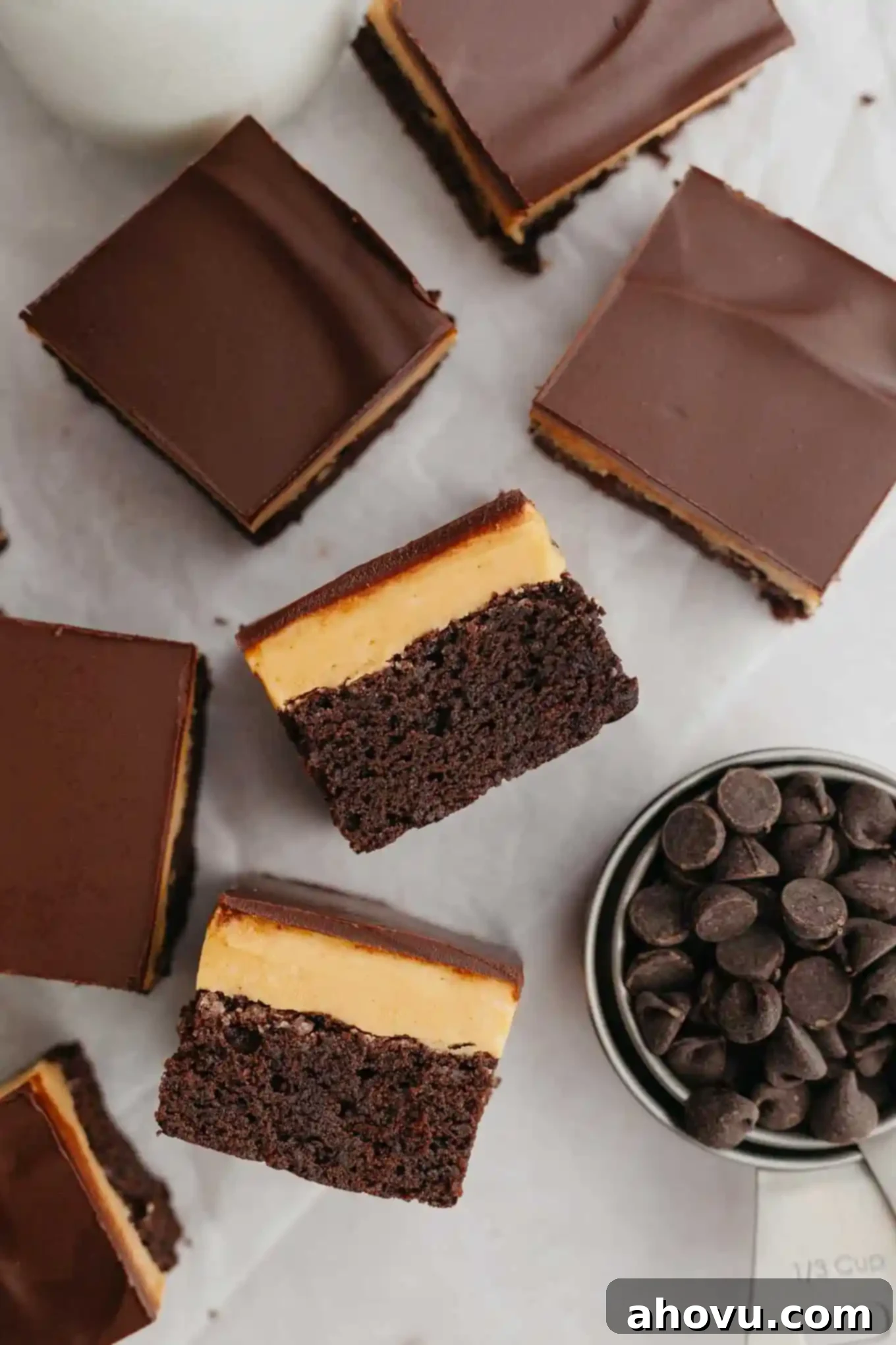 Buckeye Bliss Brownies 10 An overhead view of two Buckeye brownies, artfully turned on their sides, clearly displaying their distinct layers of chocolate brownie, peanut butter fudge, and chocolate topping.