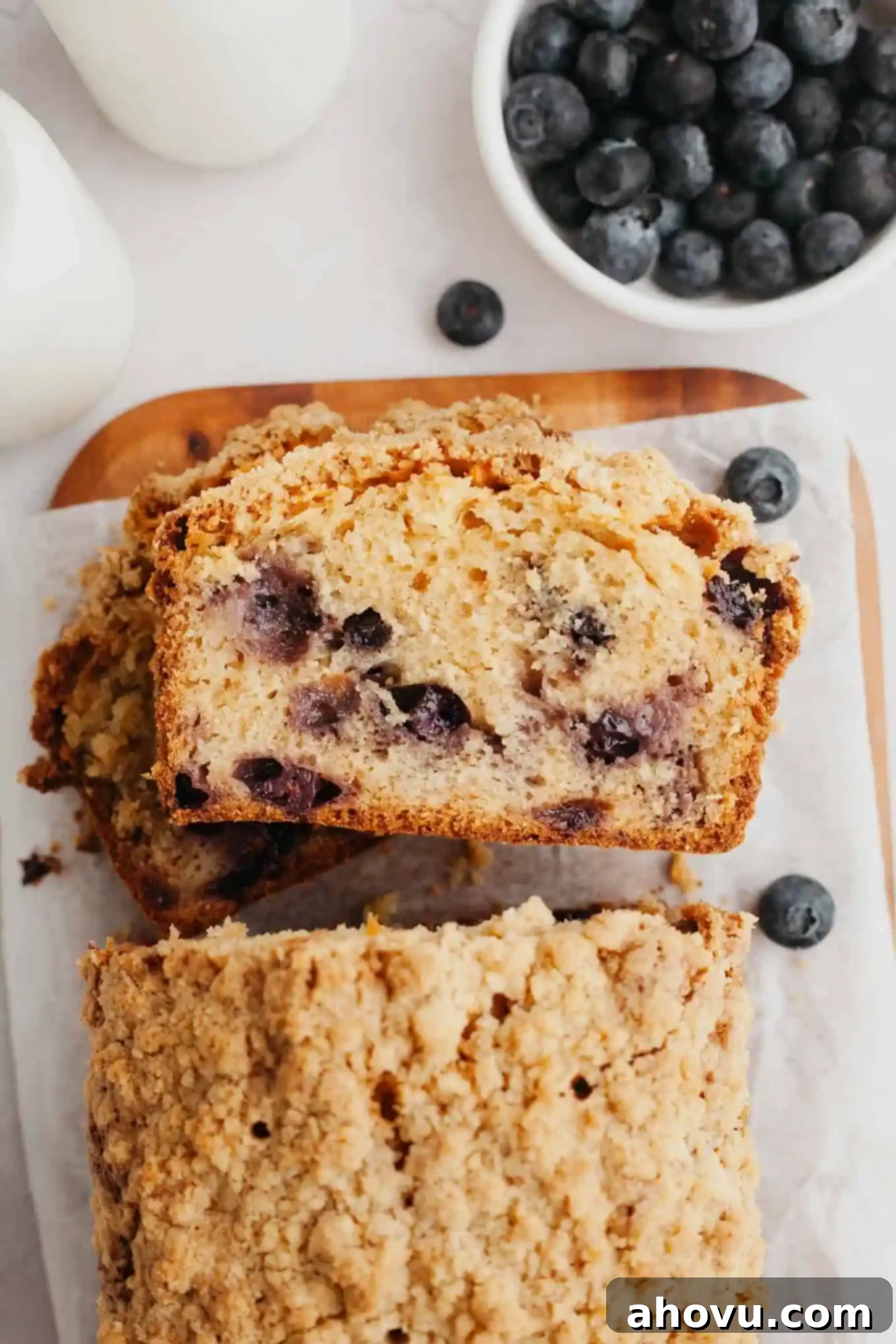 An overhead view of blueberry streusel bread slices stacked on their sides. 