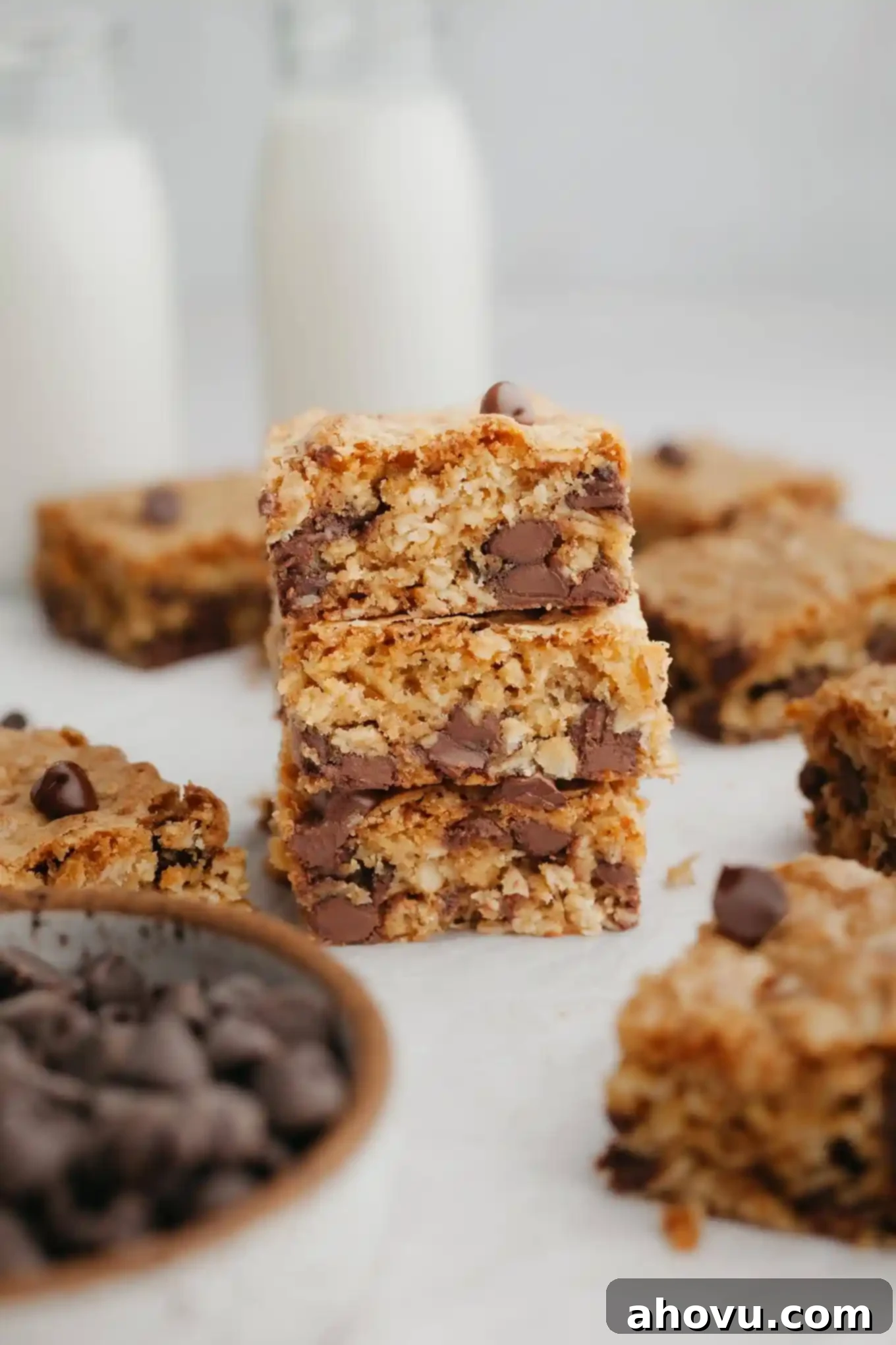 A stack of three oatmeal cookie bars, seen from the side, showcasing their soft texture and chocolate chips.