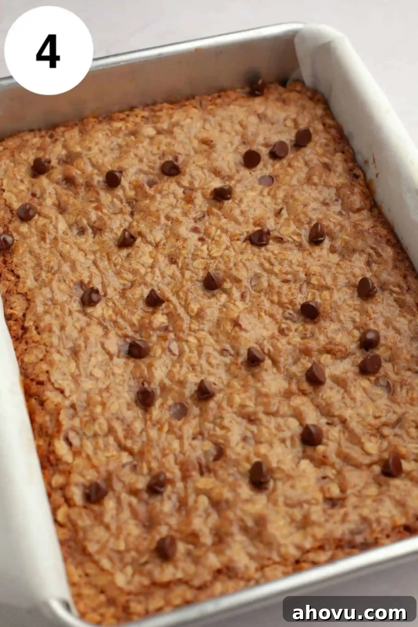 A pan of freshly baked oatmeal cookie bars, golden brown and still warm from the oven.