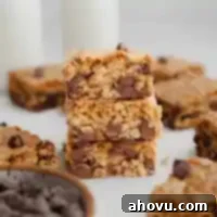 A stack of three soft and chewy oatmeal cookie bars with chocolate chips.