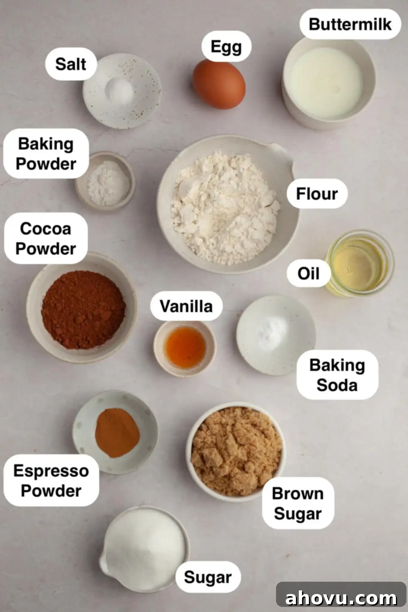 Decadent German Chocolate Cupcakes 3 An overhead view of the carefully measured dry and wet ingredients laid out for baking German chocolate cupcakes, including flours, sugars, eggs, and milk.