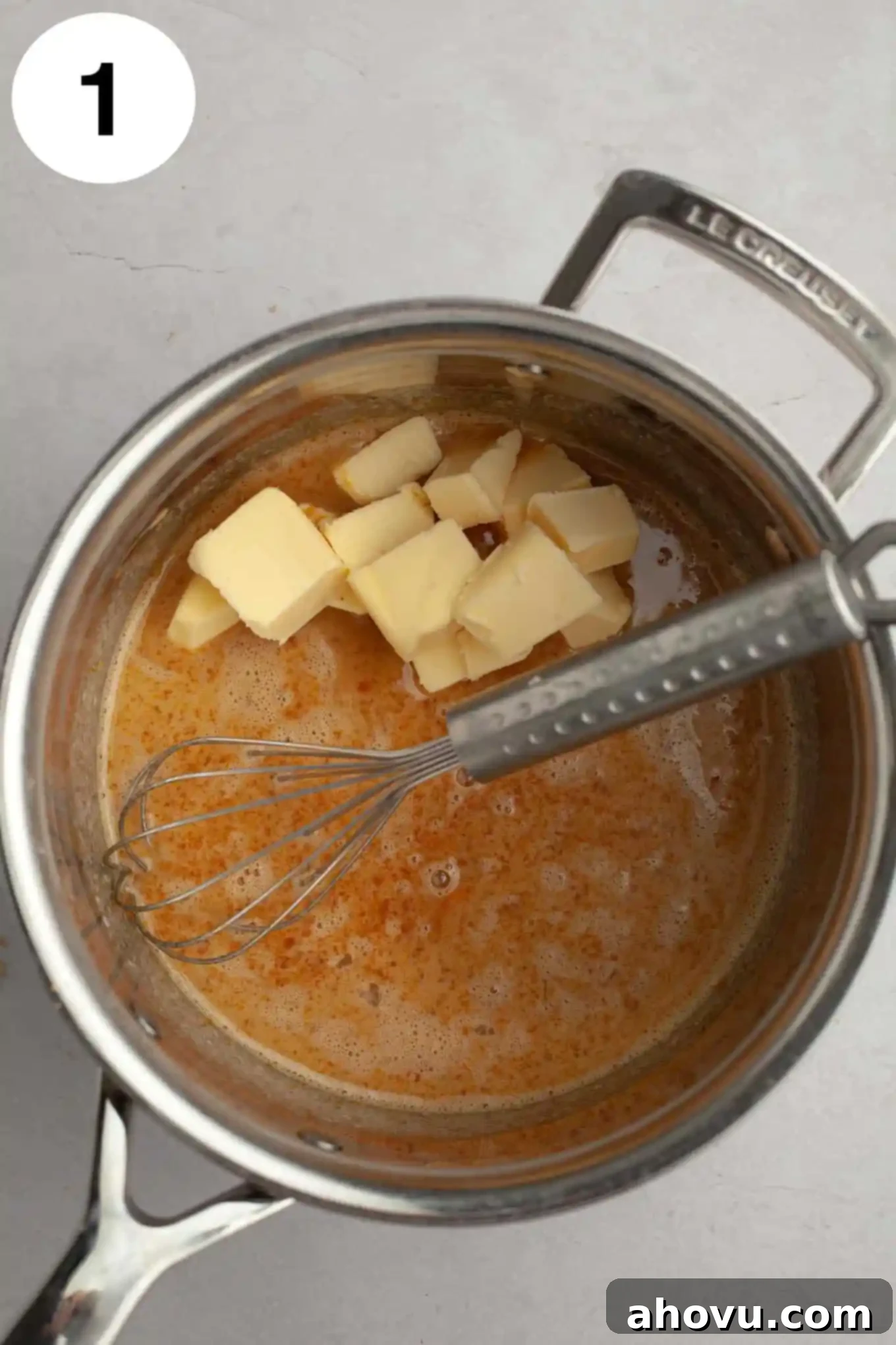 Decadent German Chocolate Cupcakes 5 An overhead shot of the key ingredients for coconut pecan frosting simmering in a saucepan, including melted butter, evaporated milk, egg yolks, and brown sugar, just beginning to thicken.