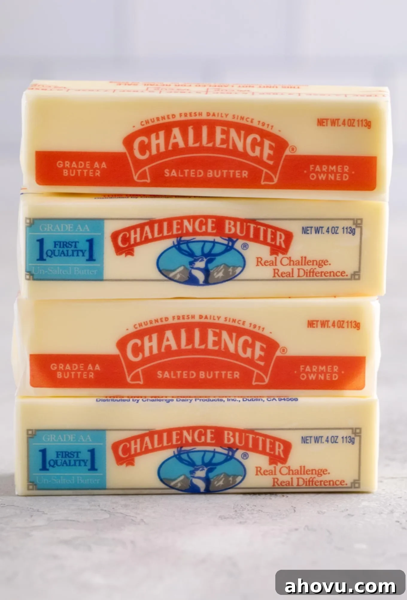 Four sticks of unsalted and salted butter stacked on top of each other.