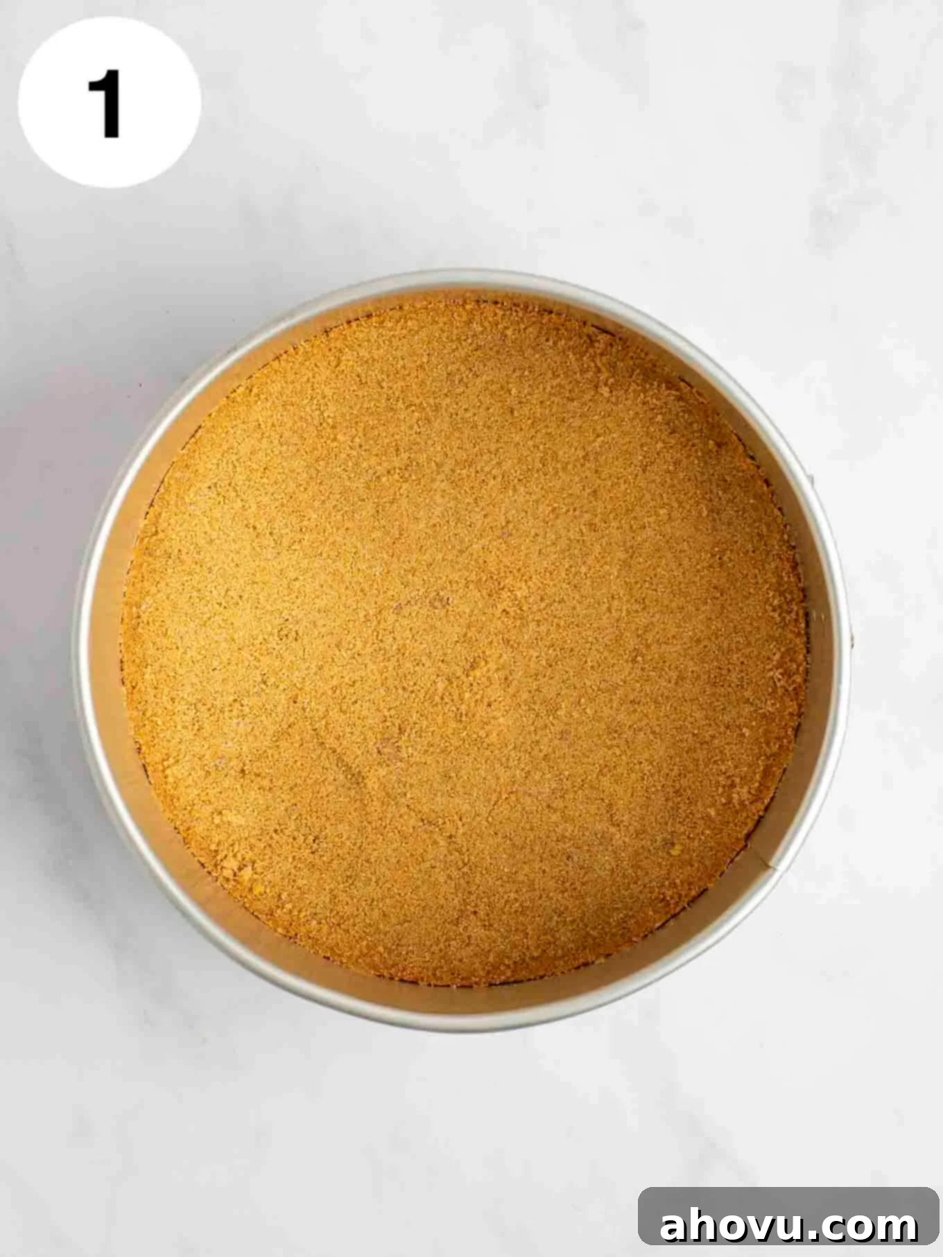 Your Guide to a Perfect Cheesecake Water Bath 5 A graham cracker crust in a springform pan.